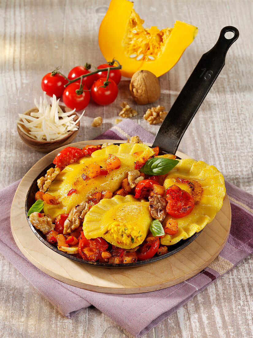 Pumpkin ravioli with cherry tomatoes and walnuts