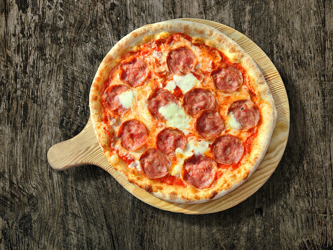 Pizza with salami and scamorza