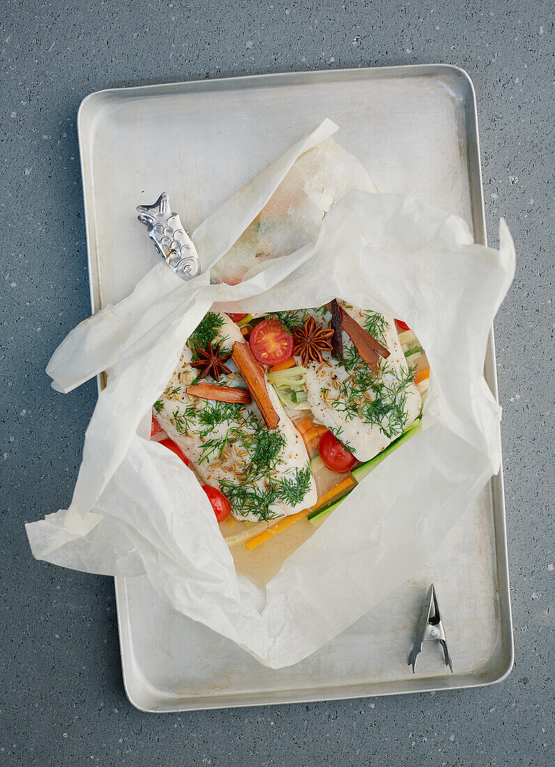Pike perch fillet with vegetables with star anise baked in parchment paper