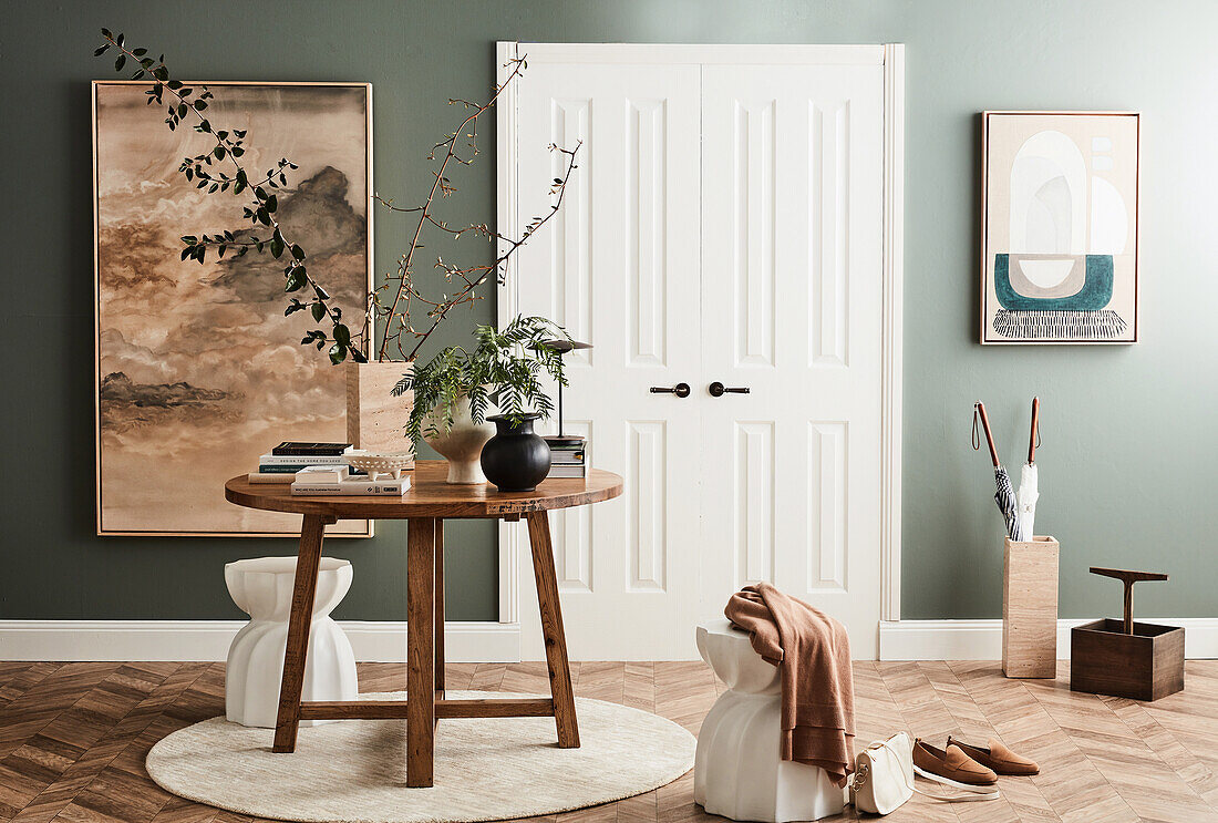 Round oak table, light concrete stool in front of white double door