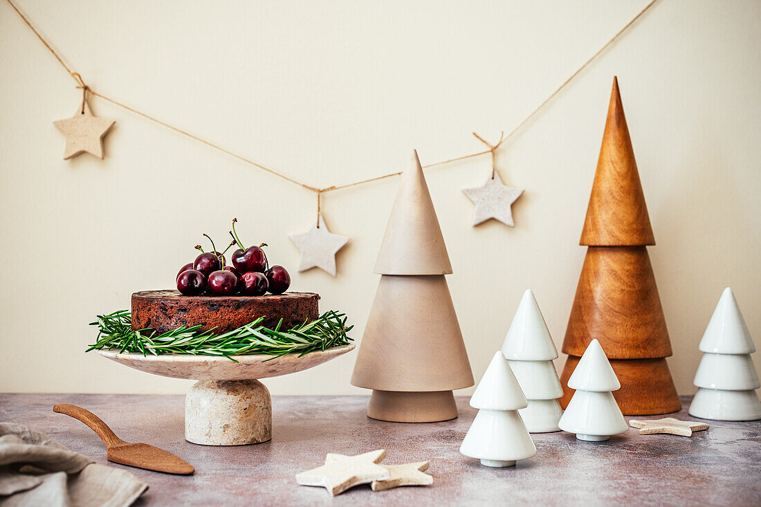 Fruit Cake in setting with Ceramic and Wooden Christmas Trees