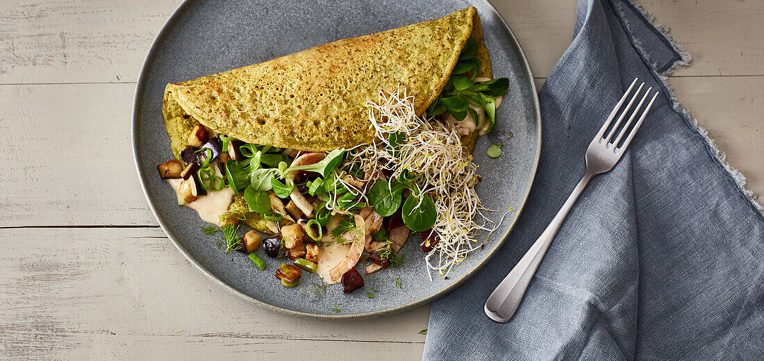 Vegan mung bean omelette with beetroot and alfalfa sprouts