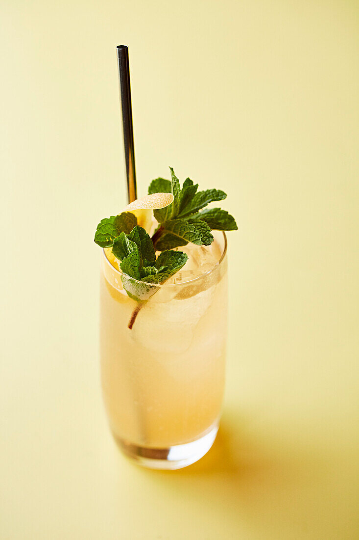 A peach cocktail with mint and lemon