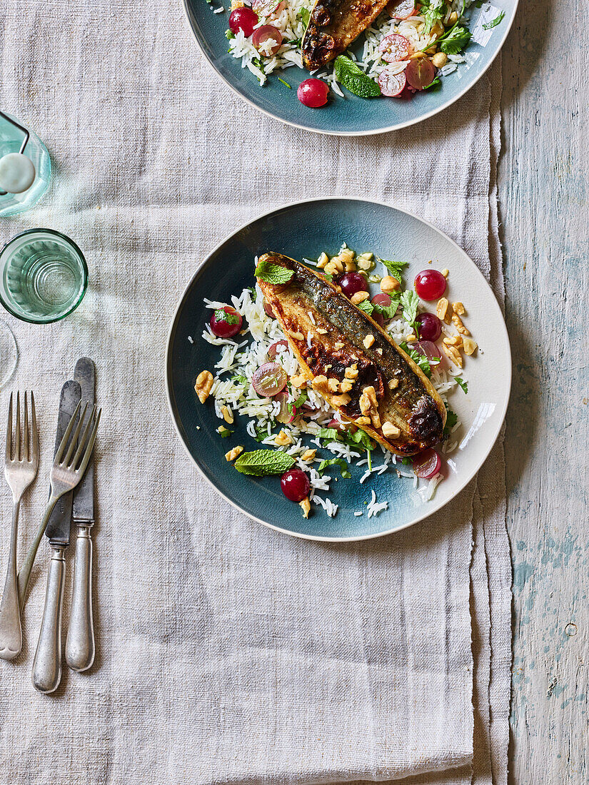 Grilled mackerel on rice salad with herbs and grapes