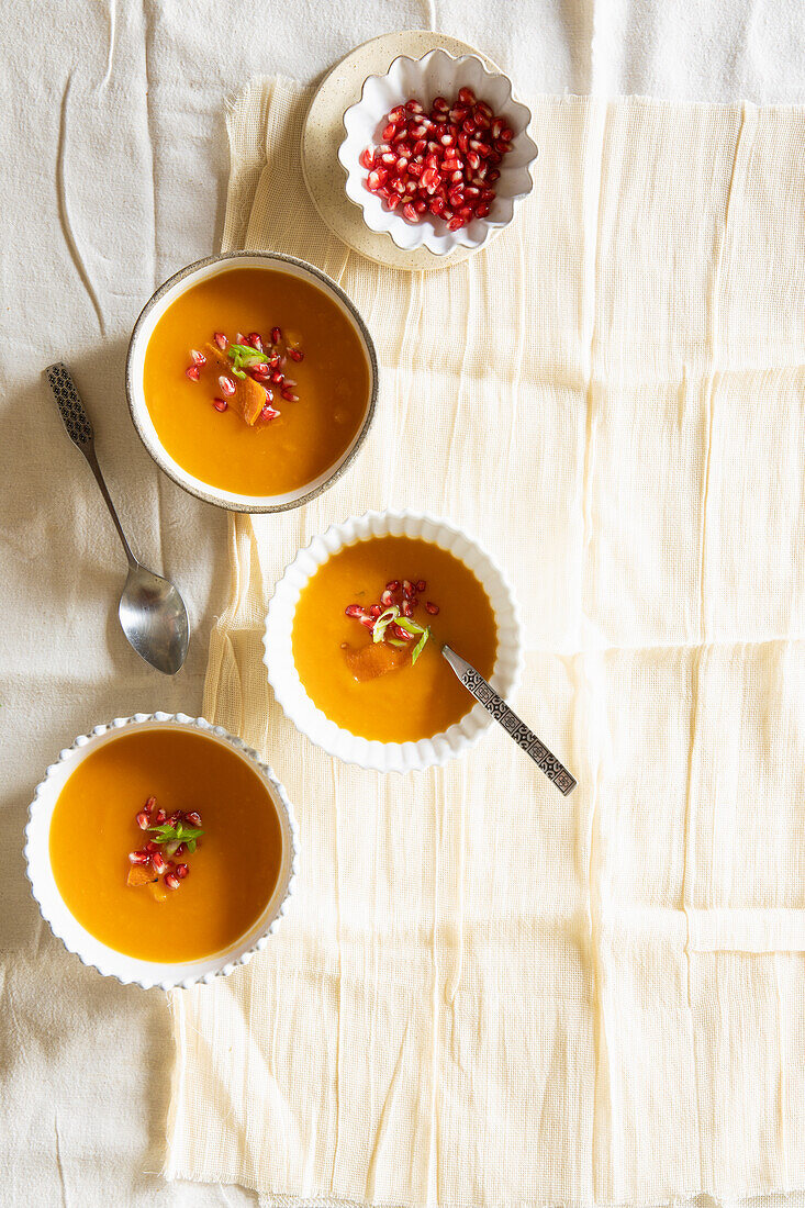 Cream of pumpkin soup with pomegranate seeds