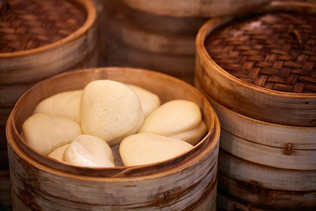 Bao buns in a bamboo steamer