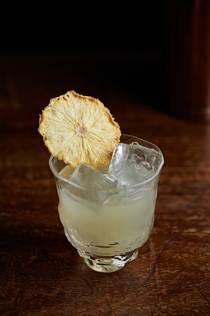 A pineapple cocktail with ice cubes