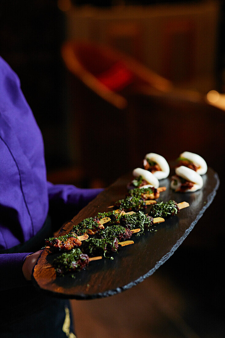 A person serving canapés