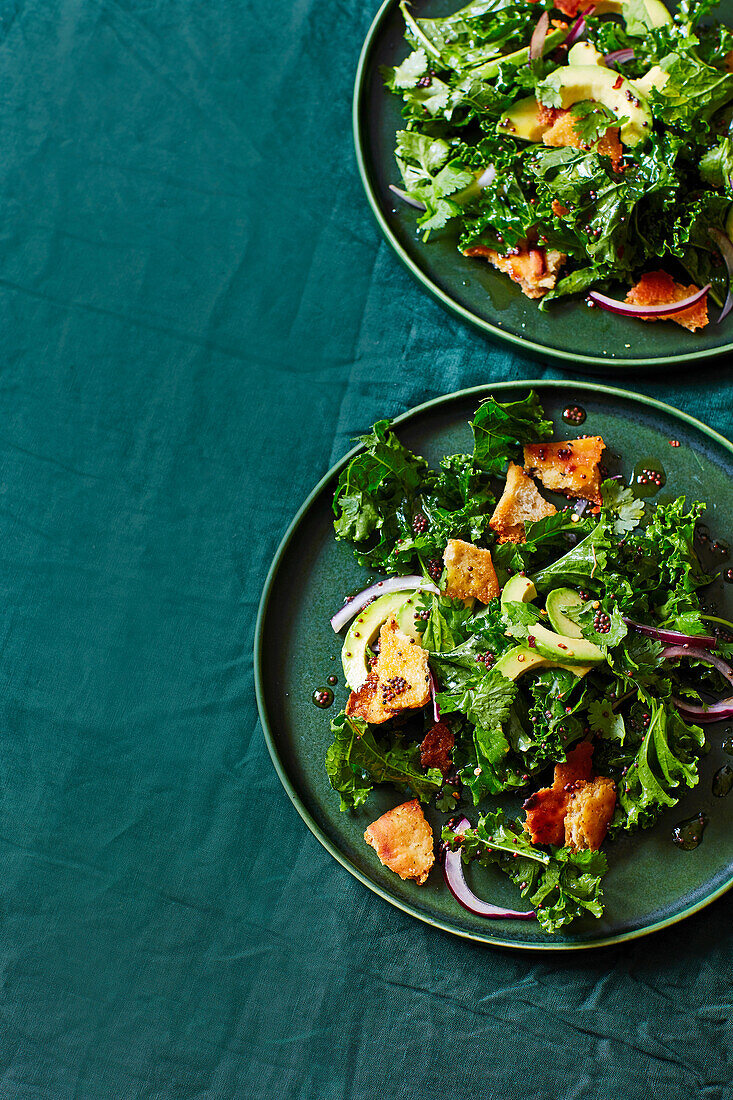 Kale salad with tadka dressing and naan croutons