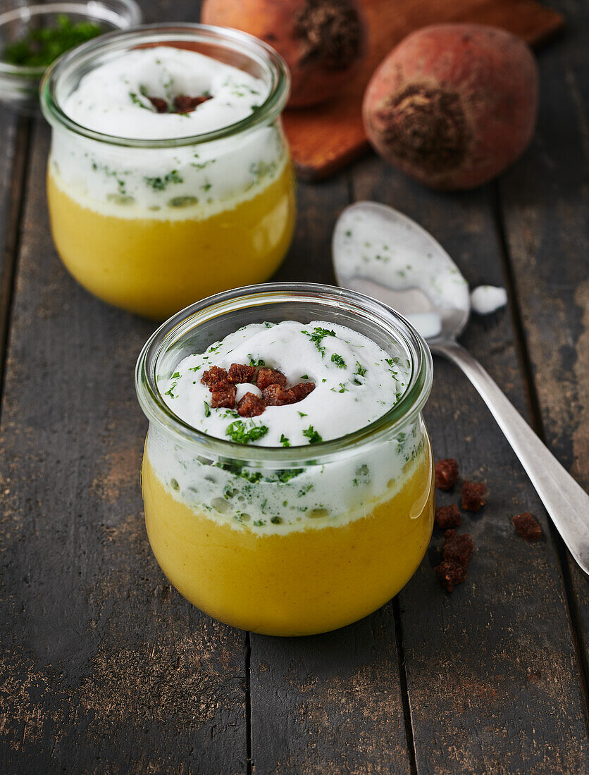 Yellow beetroot soup with cream topping