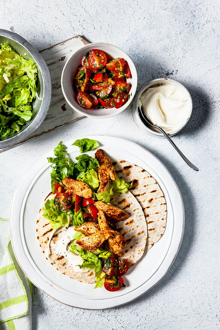 Fried chilli chicken with gem lettuce, sour cream and toasted soft tortillas