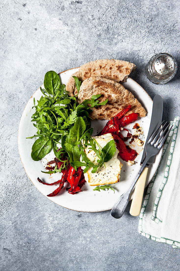 Baked feta cheese with a roast red peppers and a sun dried tomato paste, pitta bread and a green salad