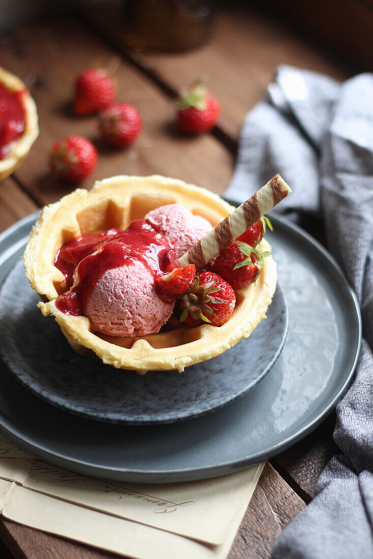 Waffle cup with strawberry ice cream and lime-strawberry sorbet