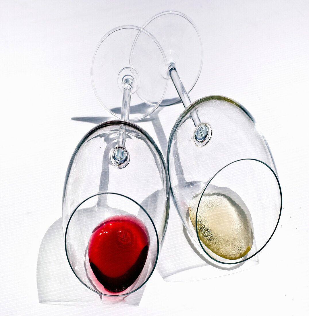 Red wine glass and white wine glass with wine residue