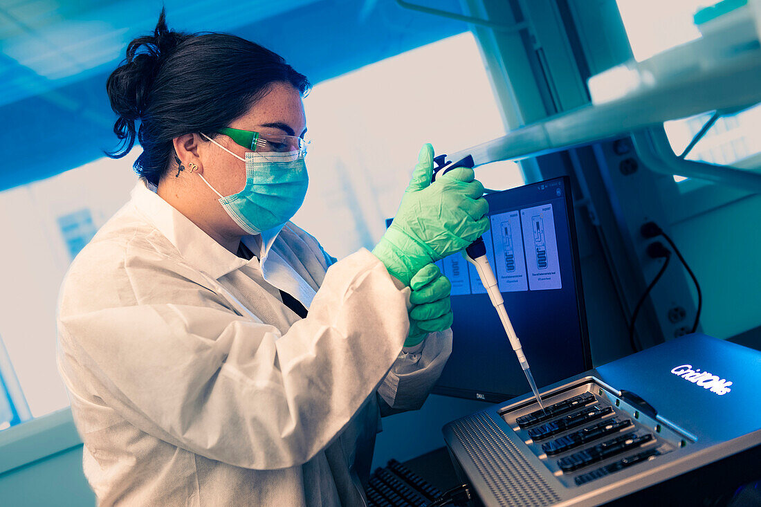 Scientist loading a sequencing instrument
