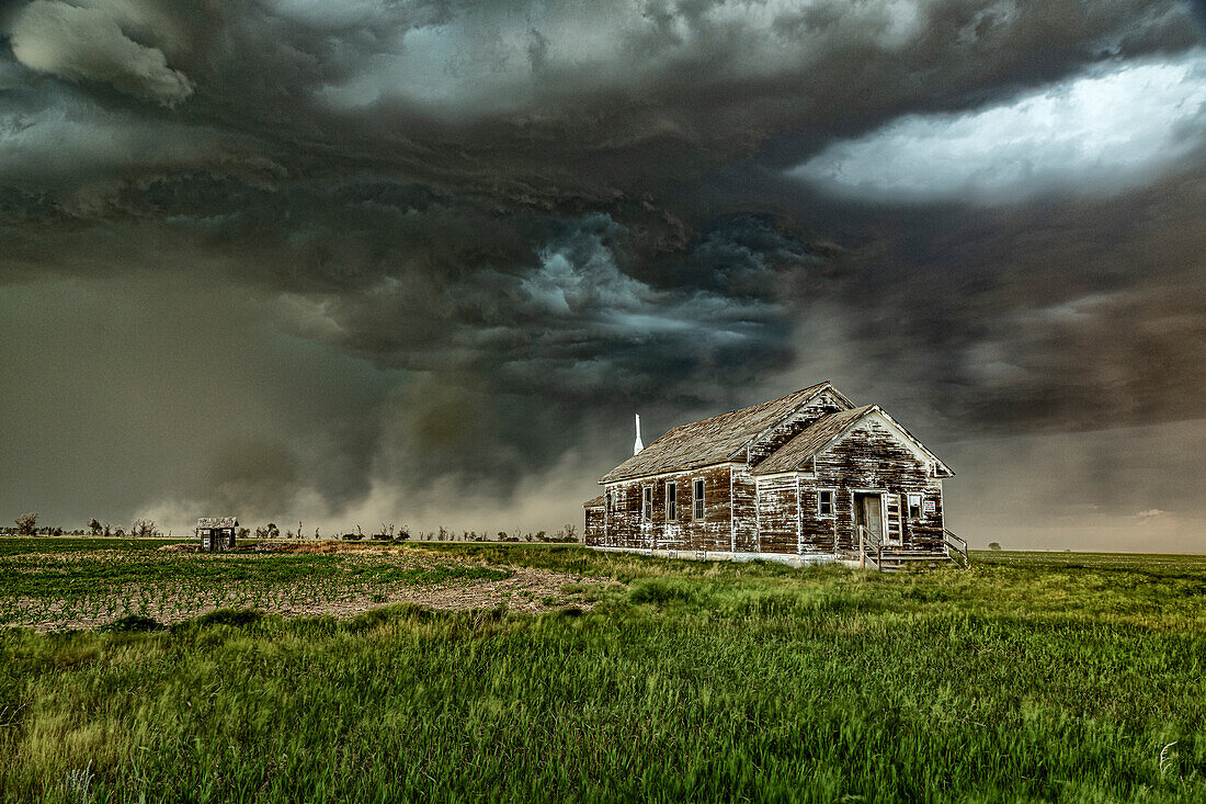 Thunderstorm over abandoned school, Nebraska, USA