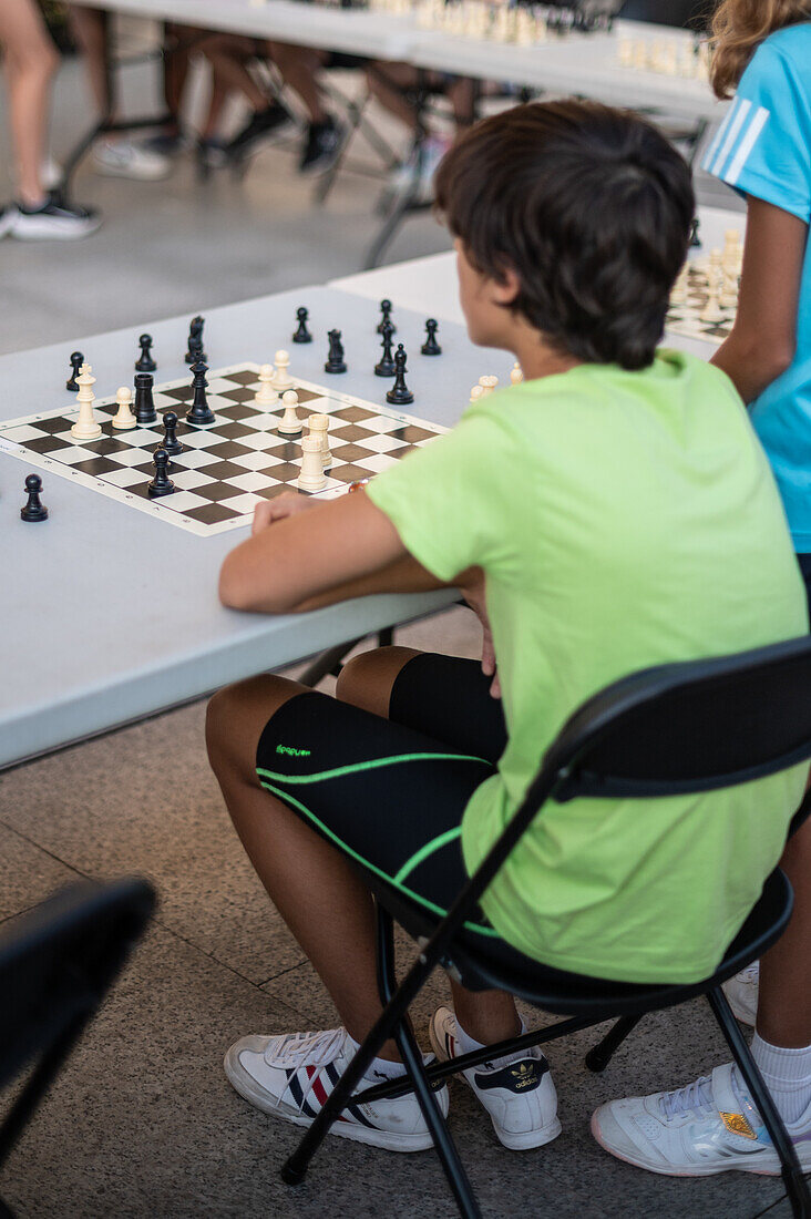 Kids playing chess at Zaragoza Sports Day, Spain