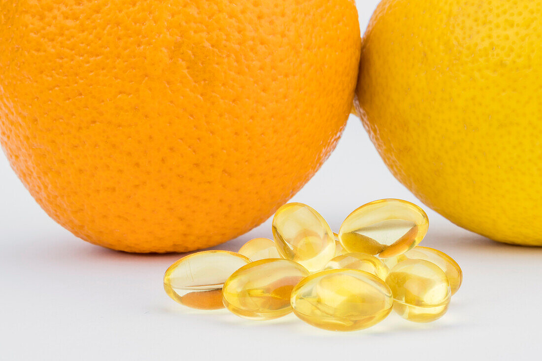 Pills next to oranges