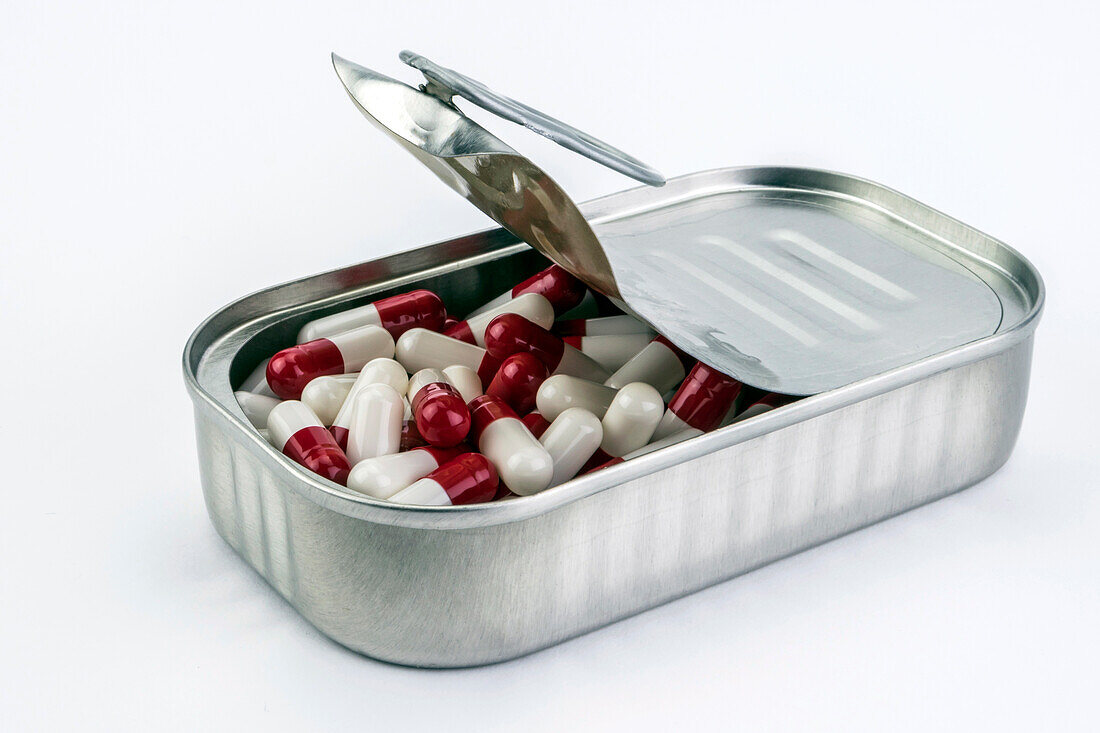 Tin metal containing white and red pills