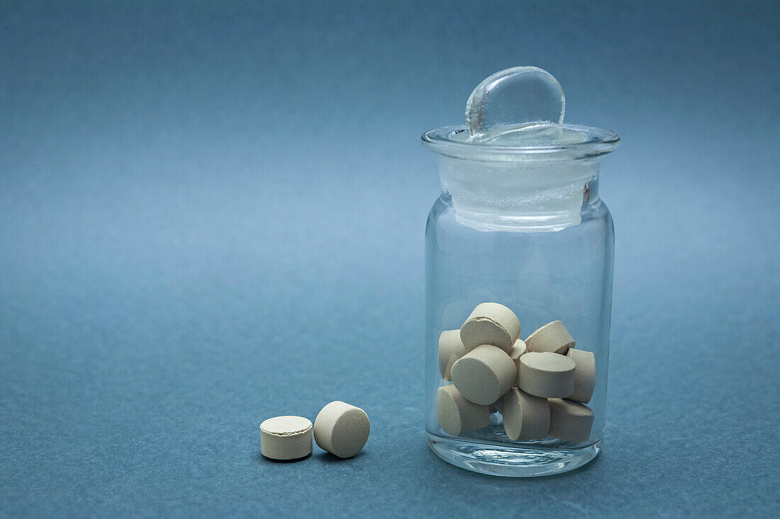 Pills in a glass bottle