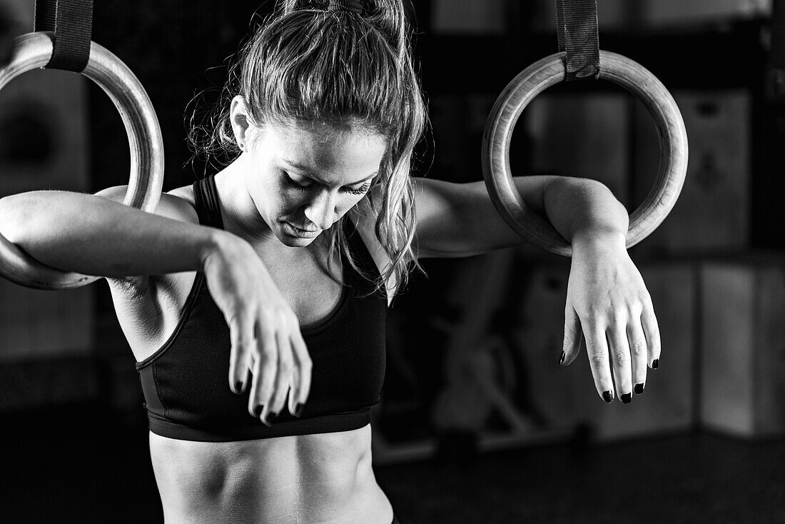 Woman cross training using rings