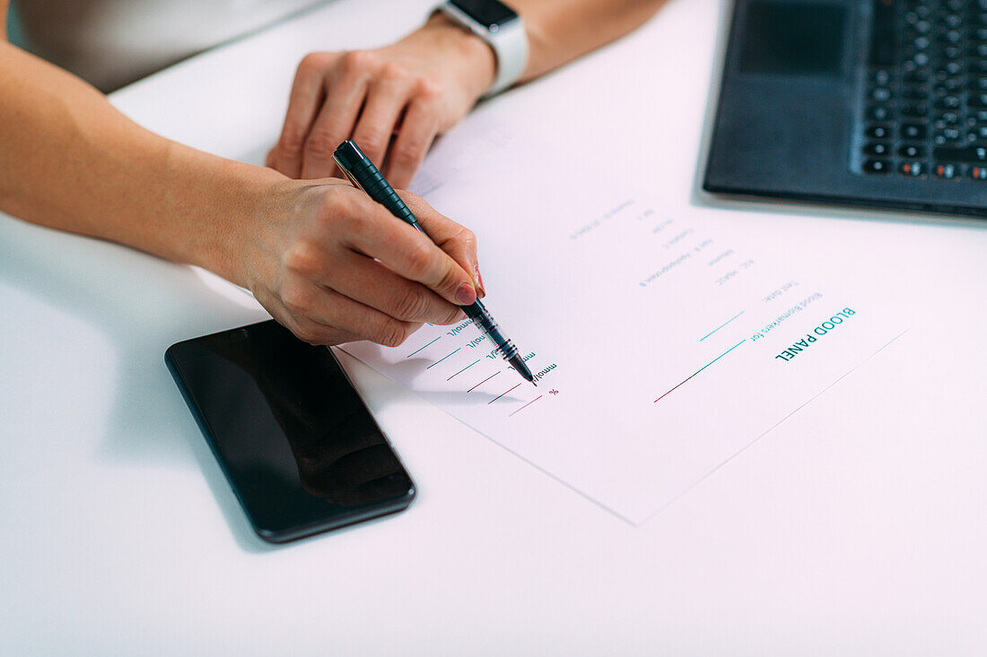 Woman writing down blood test results on a form