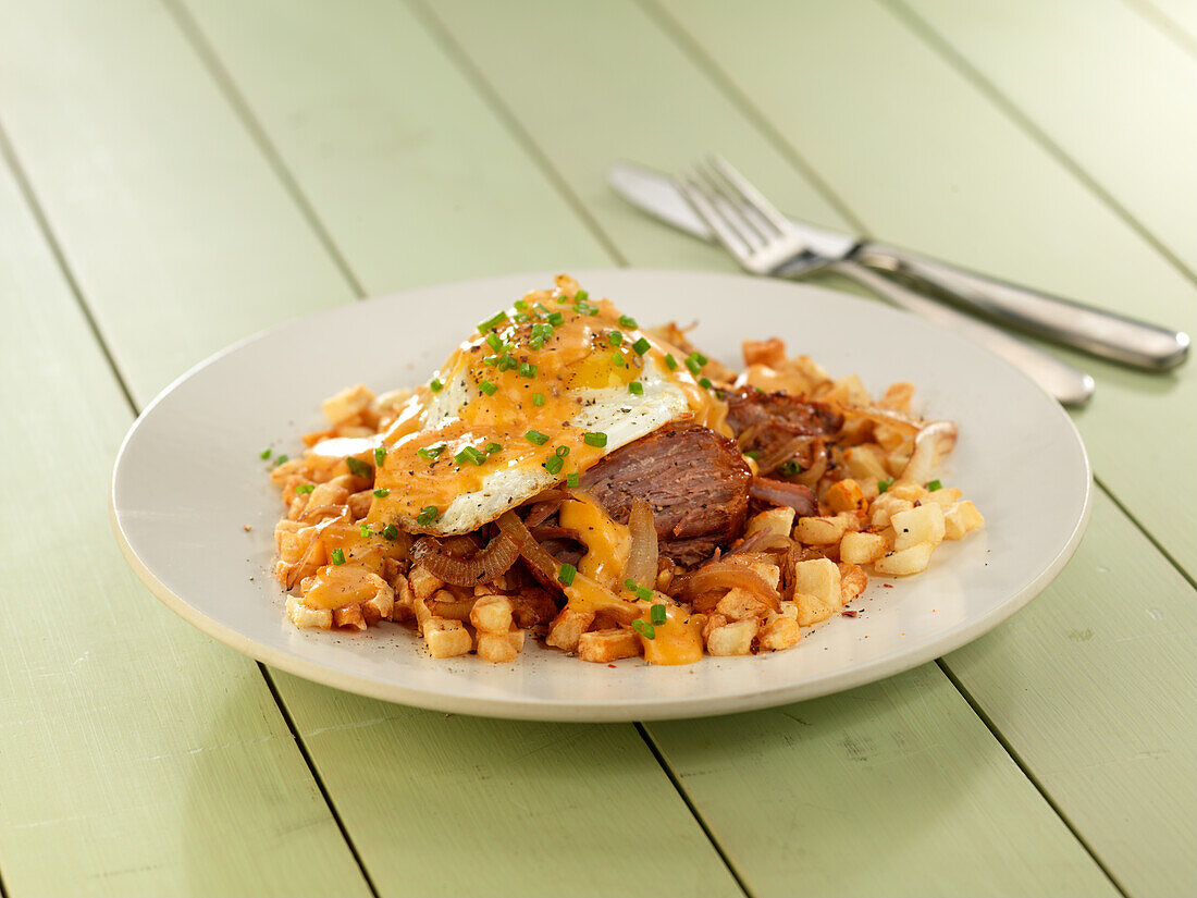 Steak with potatoes, cheese and fried egg