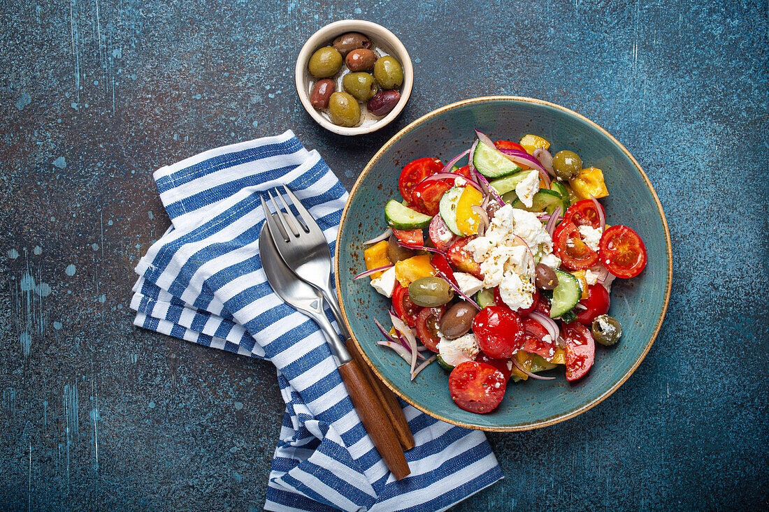 Greek fresh healthy colorful salad with feta cheese, vegetables, olives