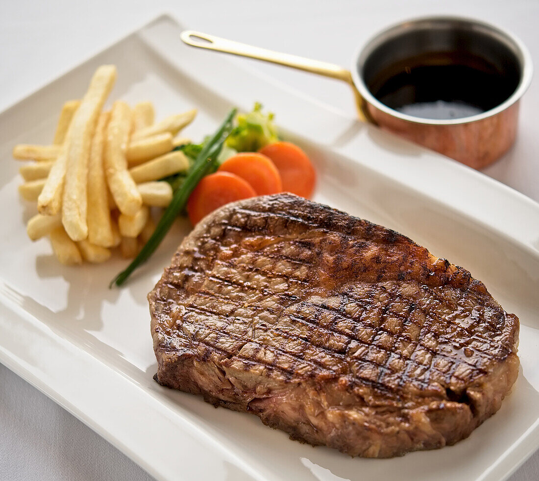 A beef steak with chips