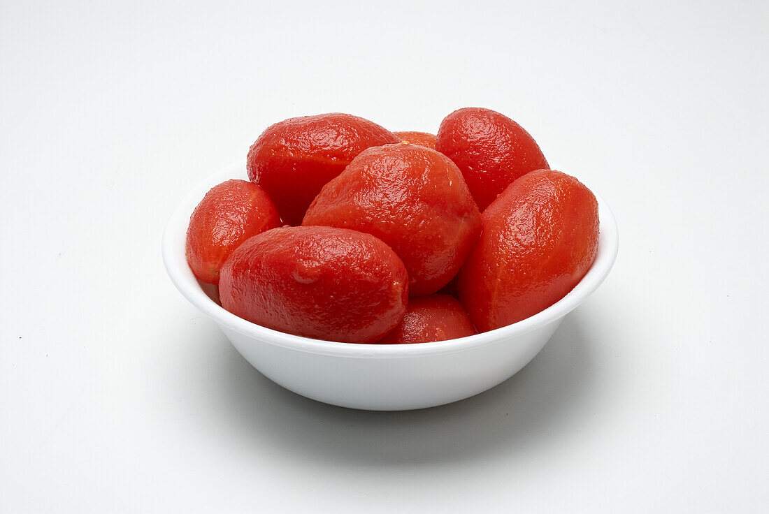 Whole peeled tomatoes in a small bowl