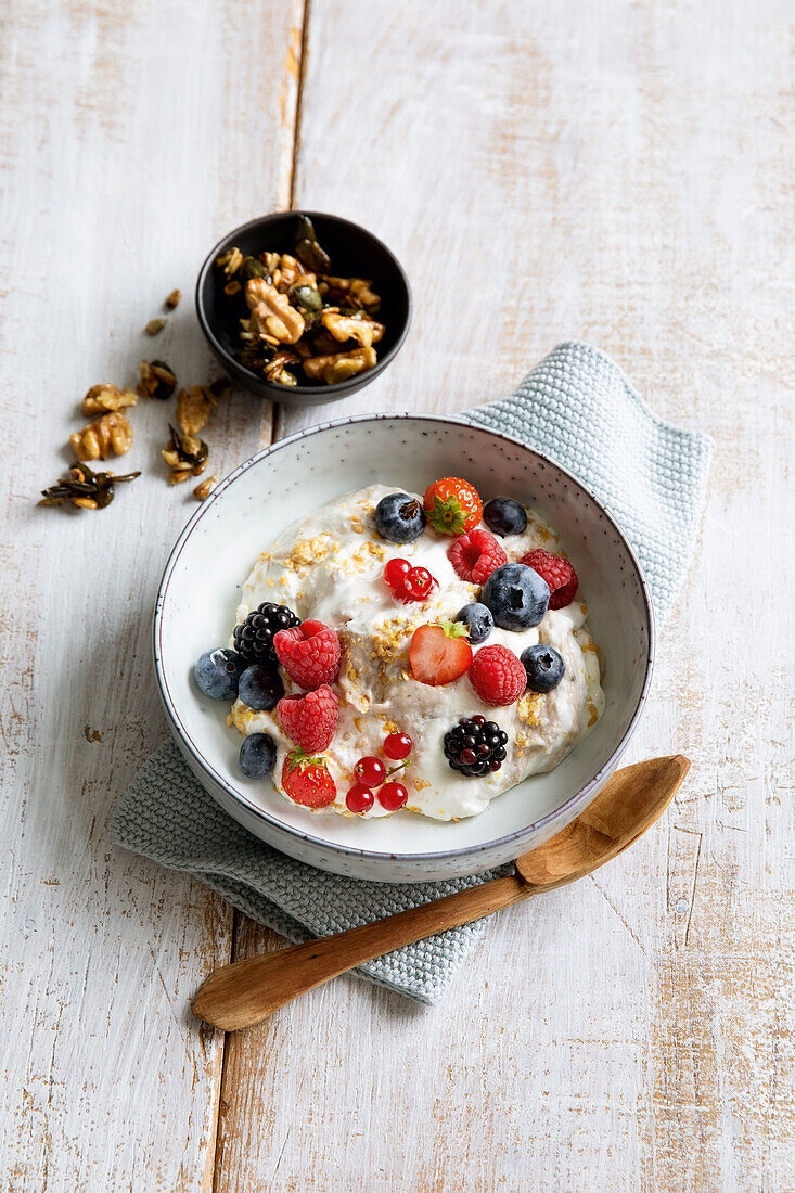 Banana curd cream with honey, seeds, and berries