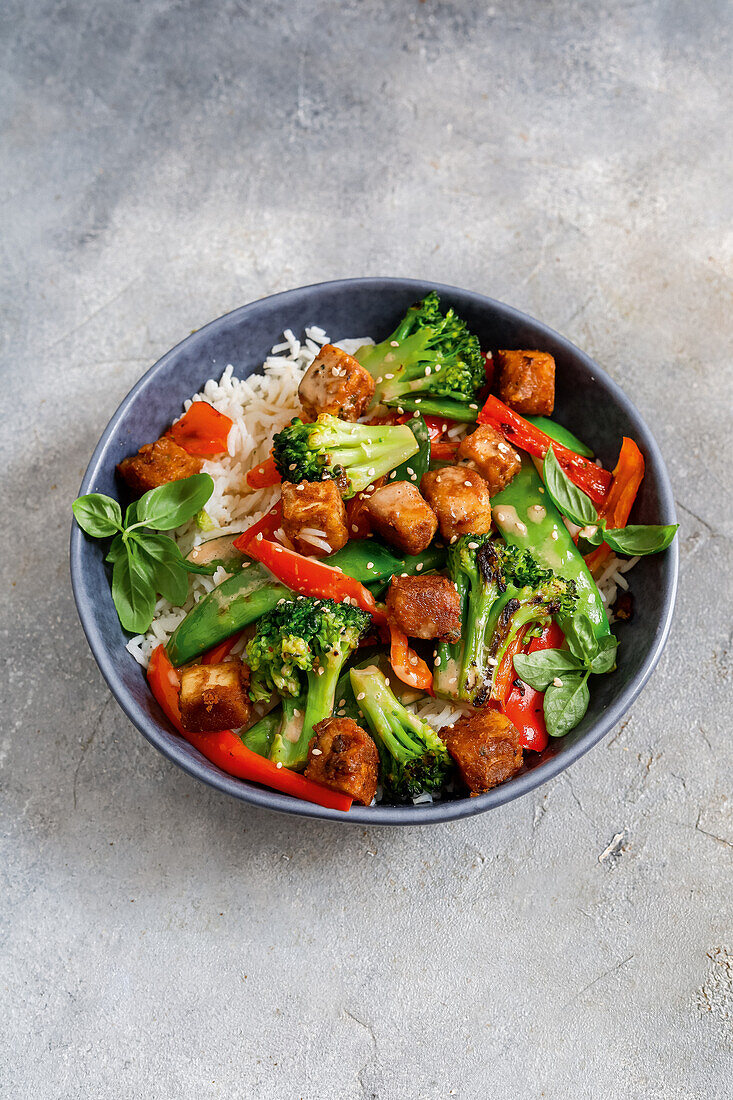 Peanut tofu with colorful vegetables on rice