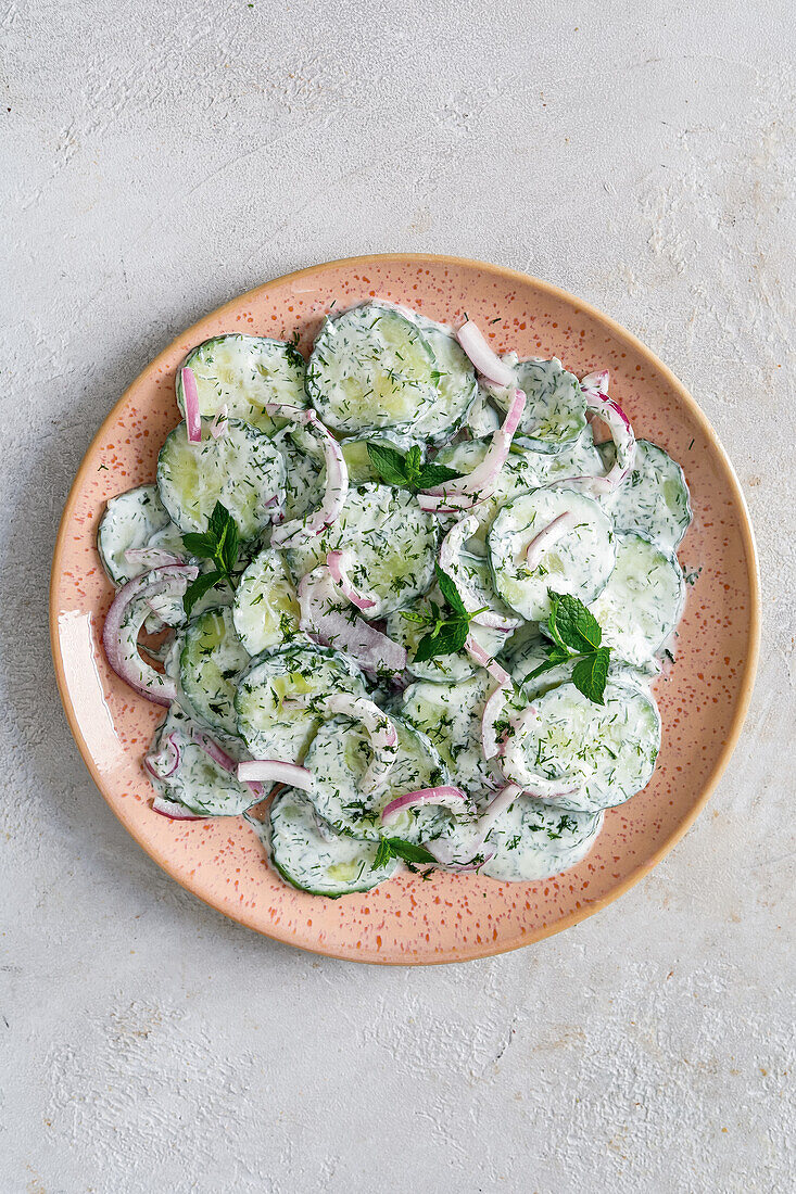 Cucumber Dill Salad with Purple Onion; In Stacked Bowls; Forks