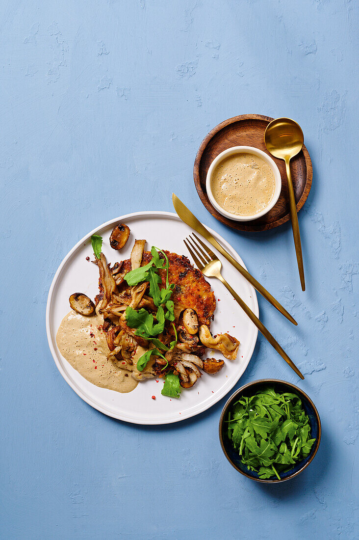 Oven rosti with vegetables, served with mushrooms and rocket salad