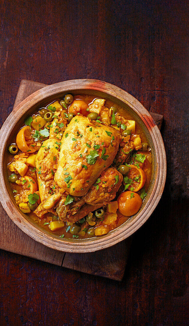 Whole braised chicken with citrus fruits and olives