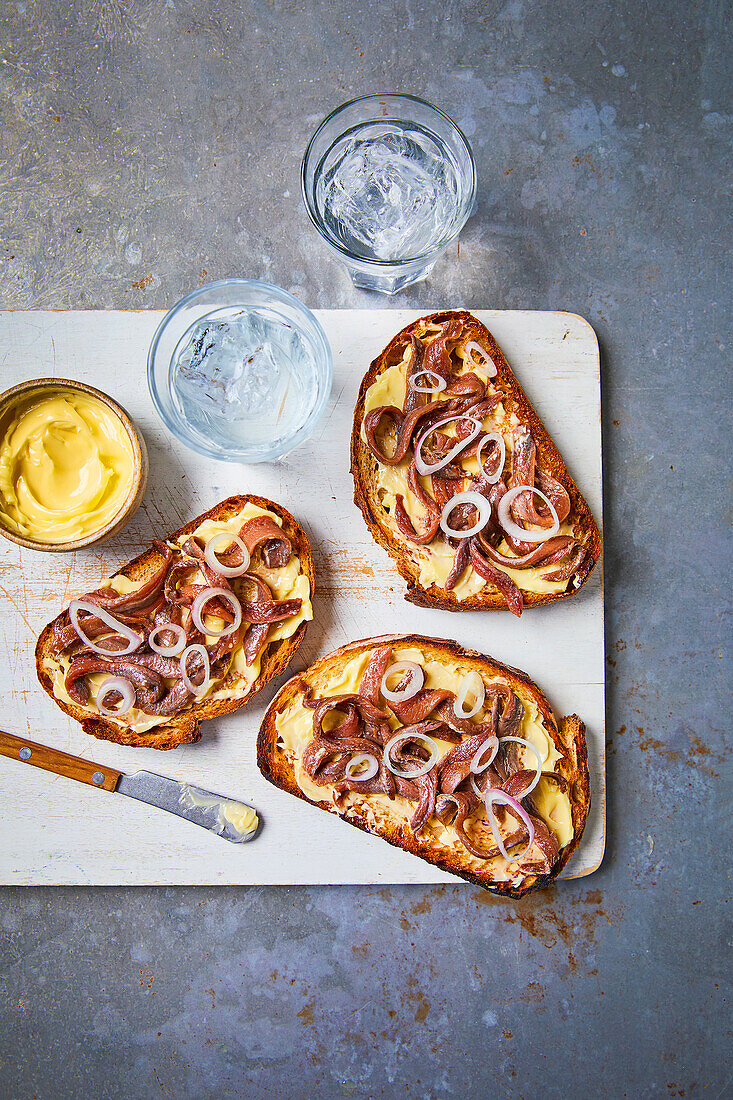Toasted bread slices with butter and anchovies