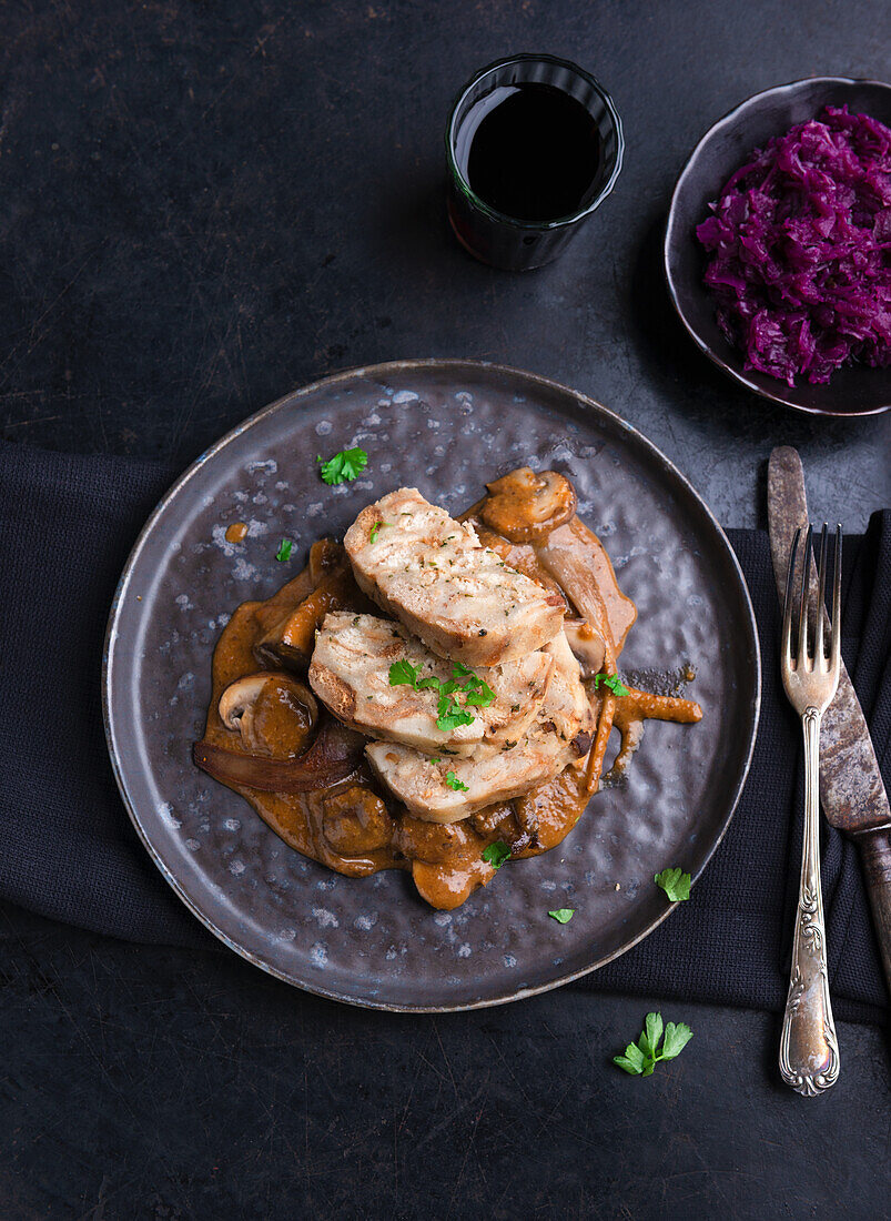 Vegan bread dumplings on a mushroom ragout of herb mushrooms, oyster mushrooms and mushrooms