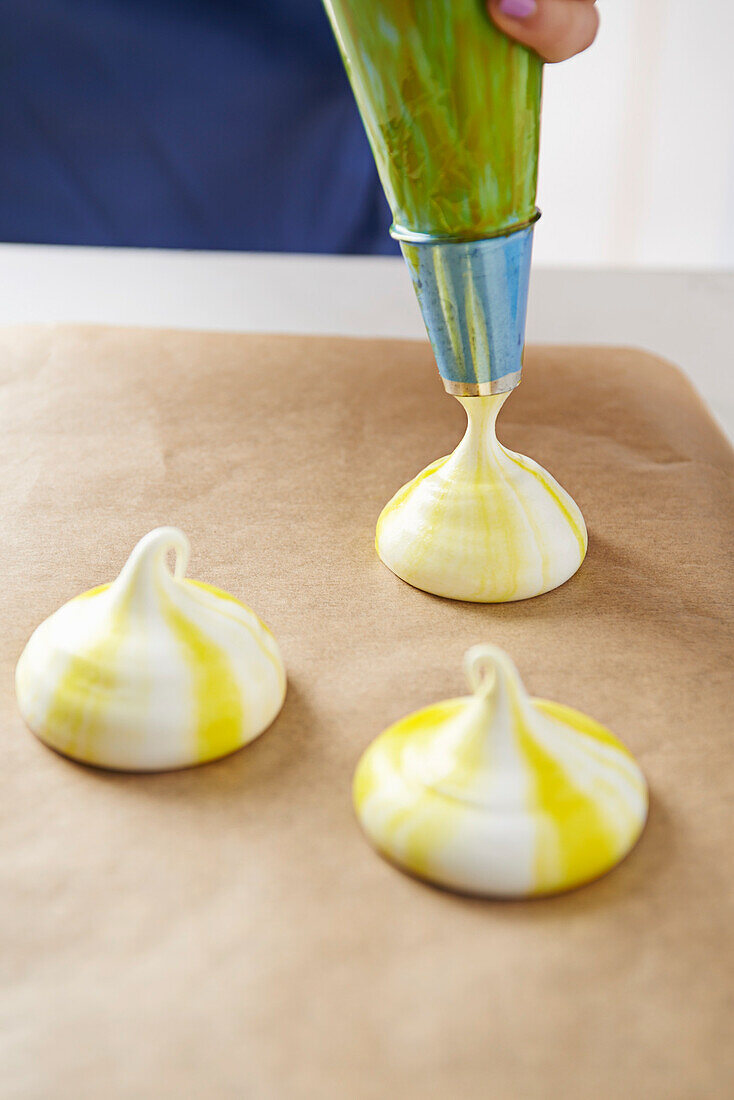 Pipe colored meringues onto baking tray