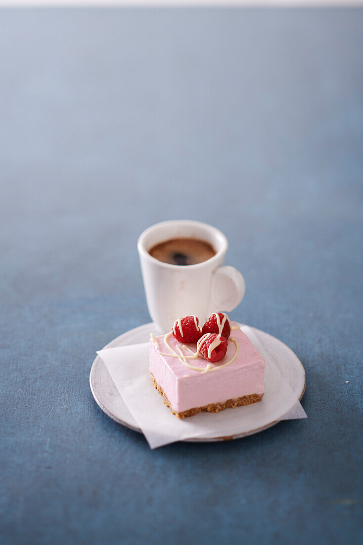 Frozen Raspberry Cheesecake with White Chocolate with a Cup of Coffee