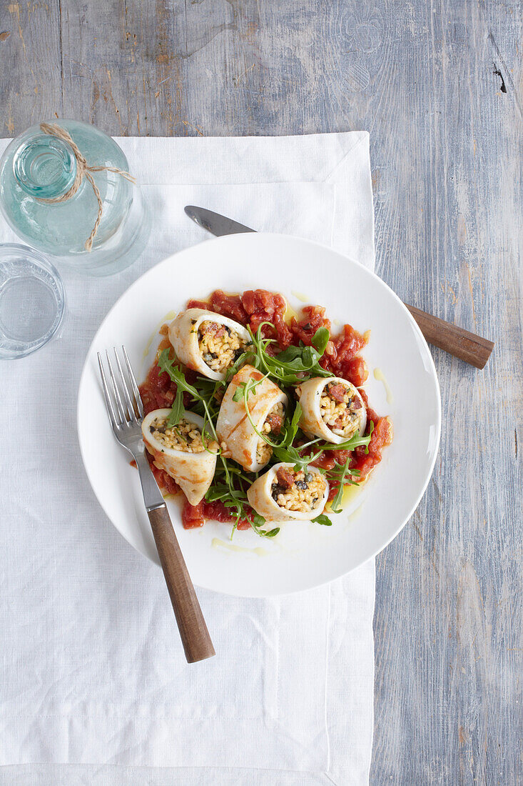 Squid stuffed with venison chorizo, olives, capers, and herb risotto