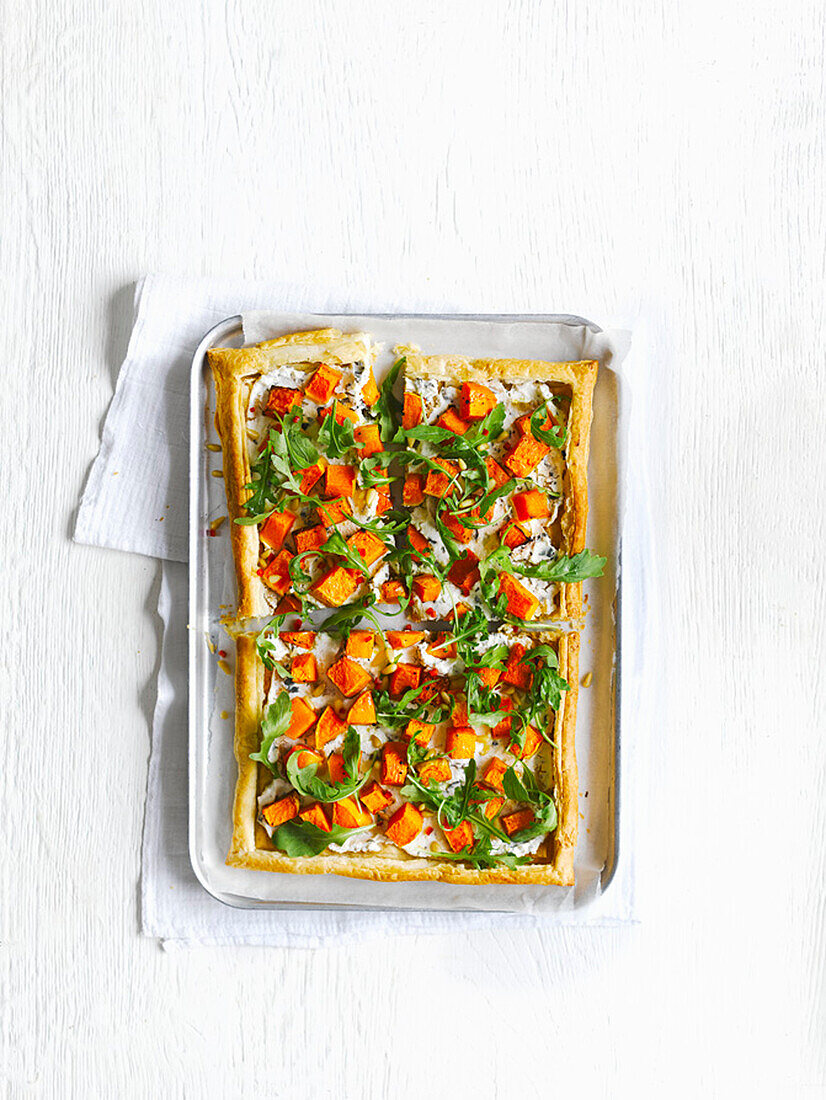 Puff pastry tart with cream cheese, pumpkin, and rocket salad