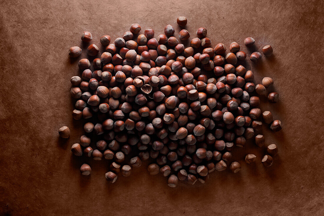 Hazelnuts on a brown background