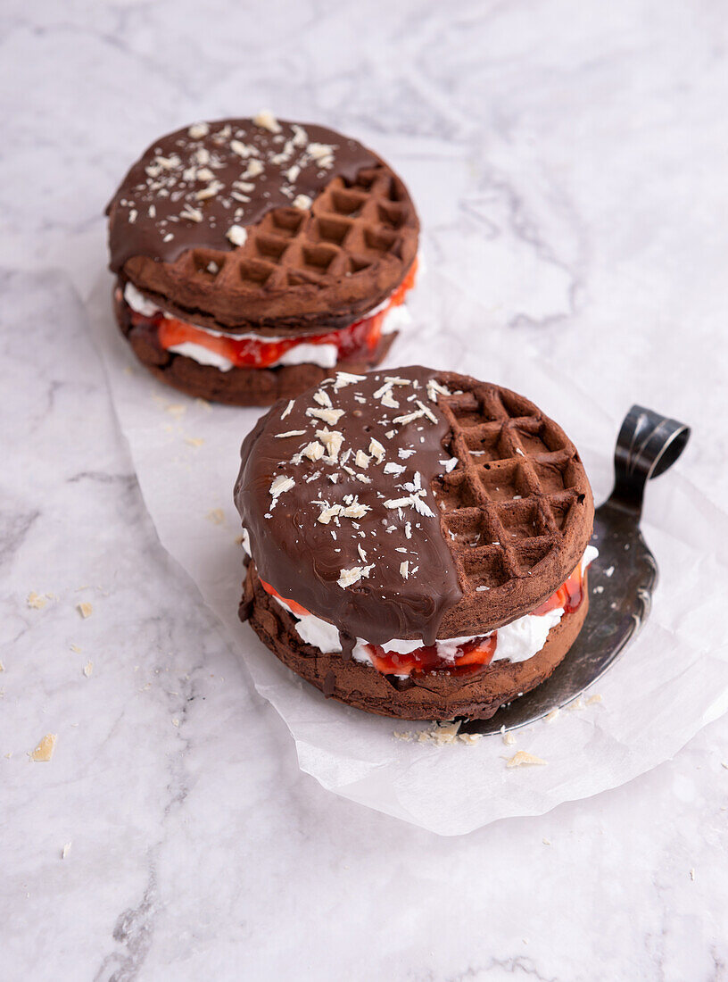 Vegan chocolate wafers with white chocolate cream, strawberry jam and plain icing