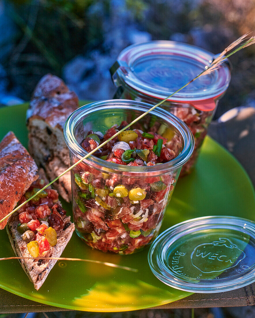 Sausage tartar in jars for a picnic