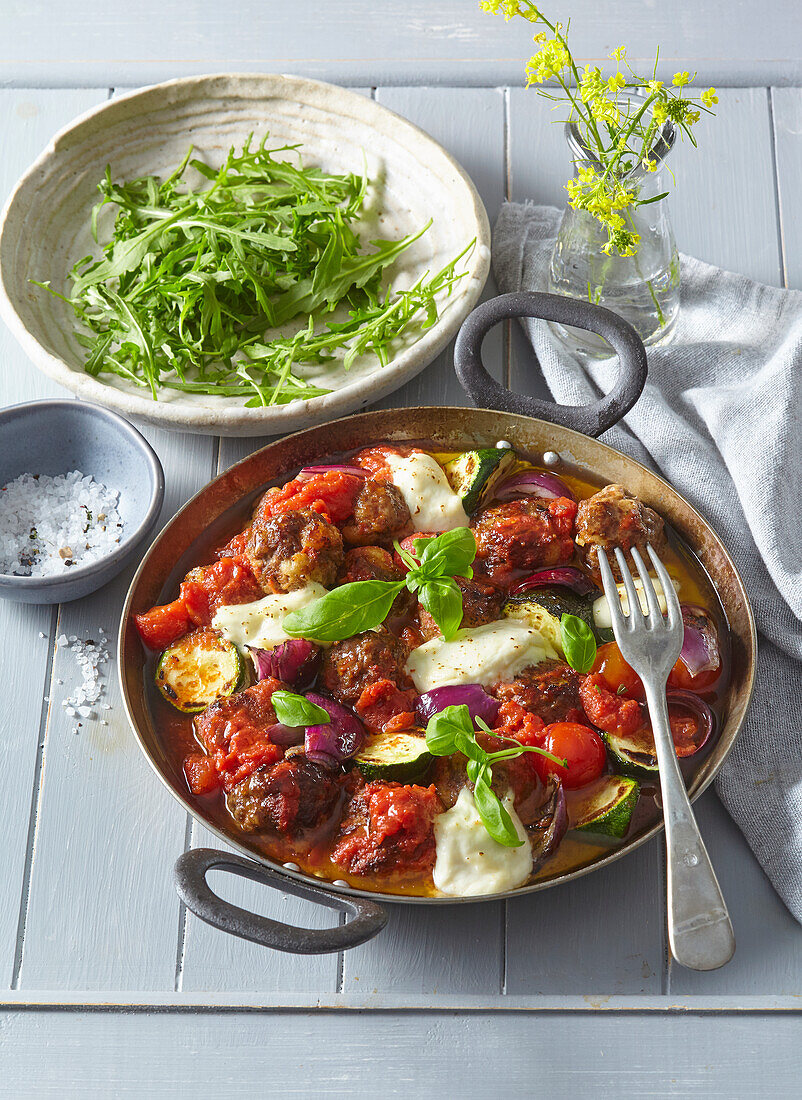 Baked meatballs with vegetables and mozzarella cheese