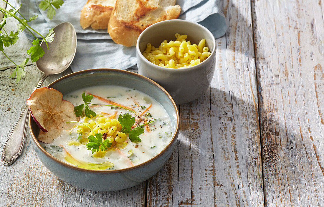 Parsley root soup with noodles and apple chips