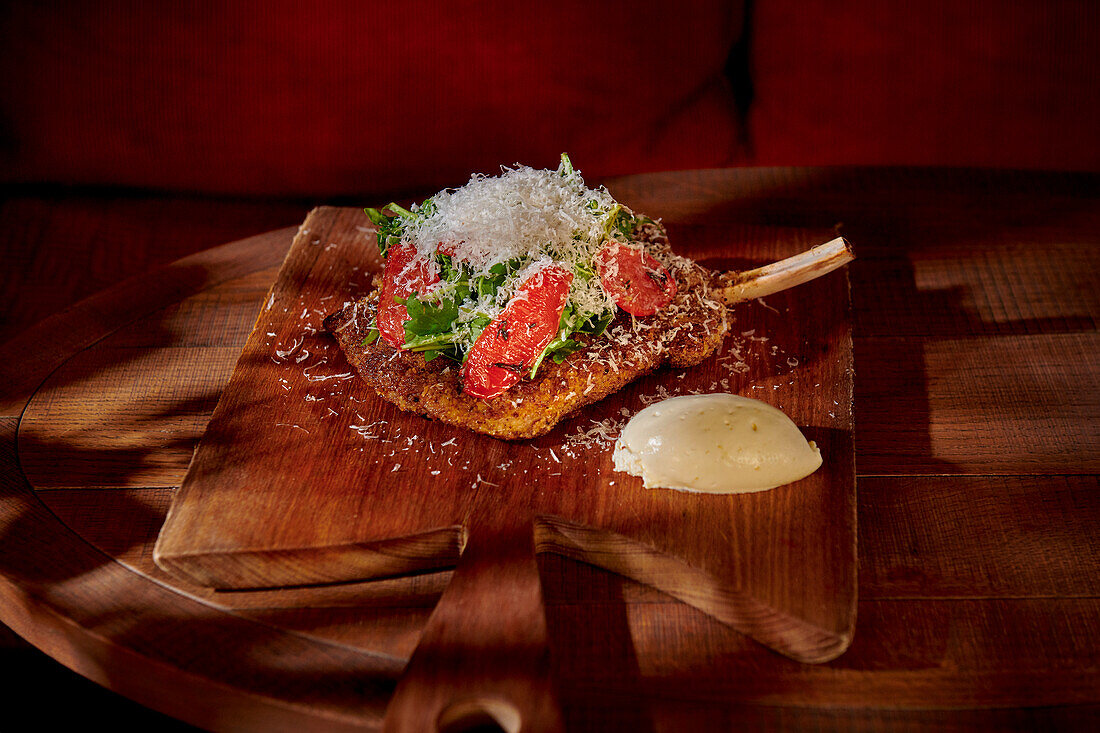 Milanese veal cutlet with tomato confit and Parmesan cheese