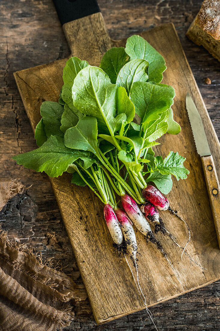 Radishes on a wooden cutting board