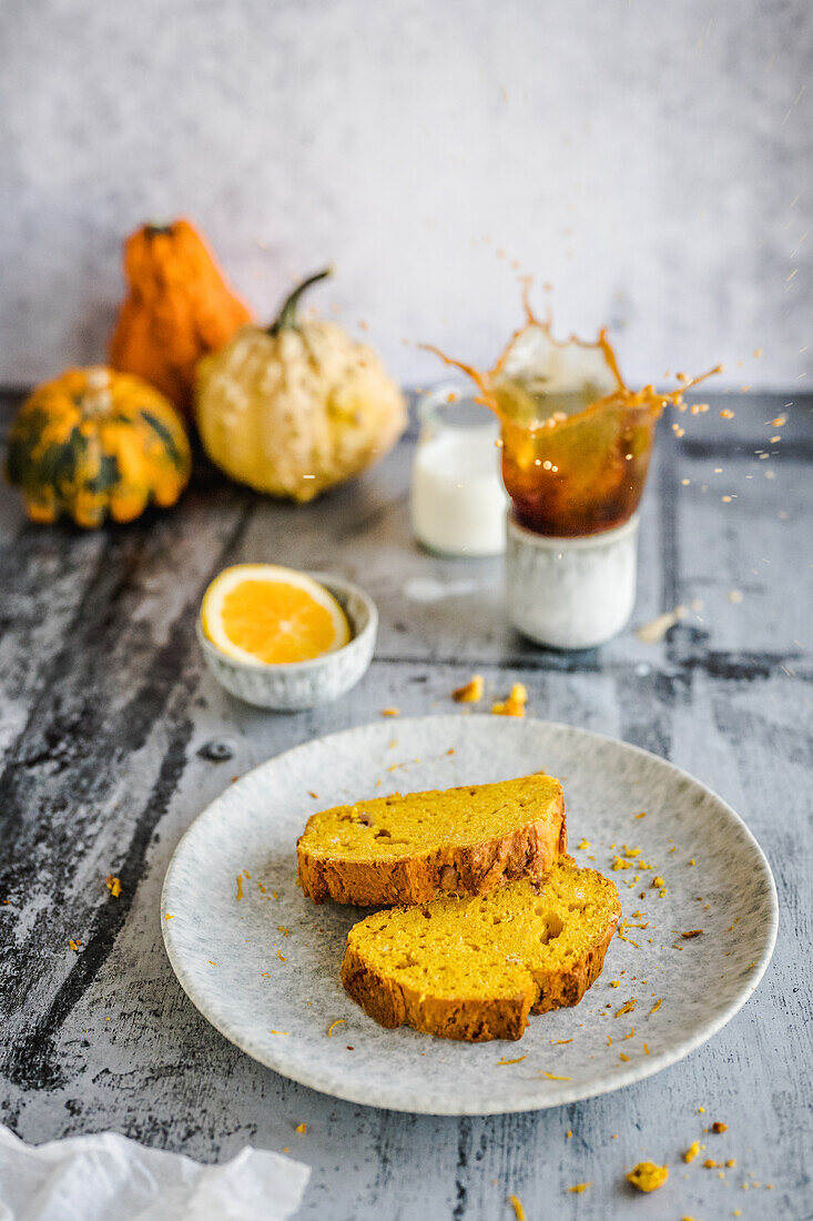 Pumpkin-orange cake and splashing coffee in the background