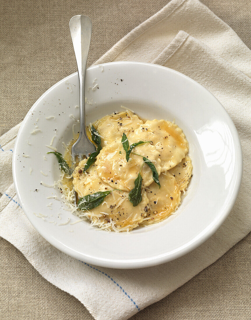 Ravioli with chicken filling and hazelnut sage butter sauce